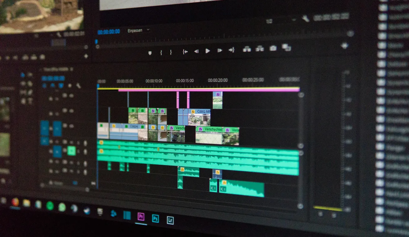 Close-up of a video editing software screen showing a timeline with multiple video and audio tracks, colorful clips, and interface elements.