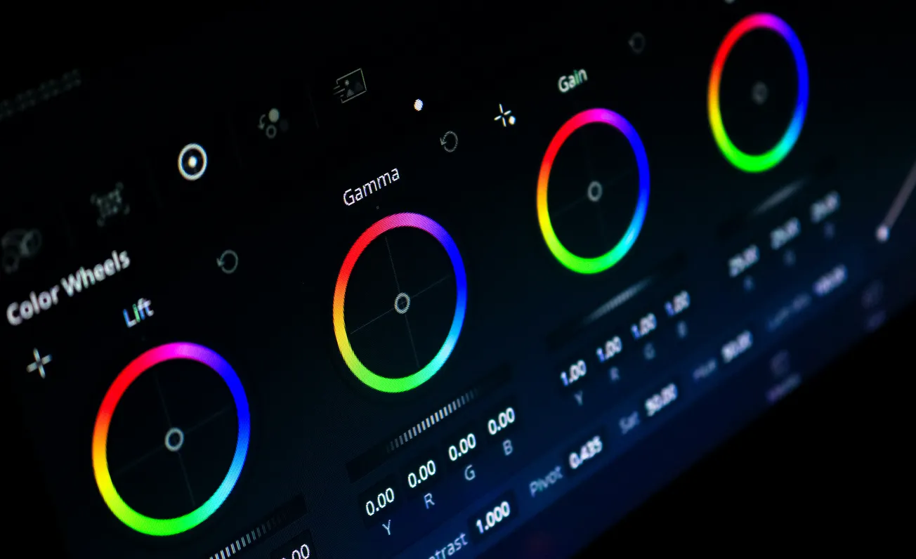 Digital interface with four colorful color wheels labeled Lift, Gamma, Gain. Bright, vivid hues on a dark background suggest editing and creativity.