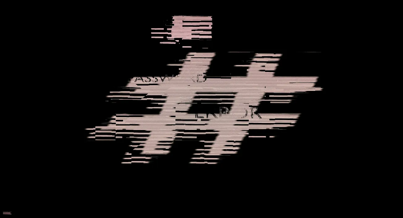 Glitched pink hashtag symbol on a black background, conveying a digital or cyberpunk theme. The image evokes a sense of disruption and modernity.